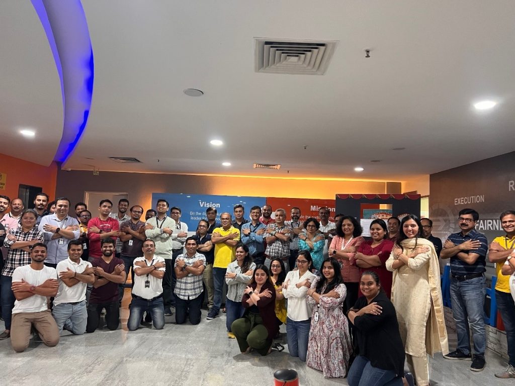 CloudMoyo employees in the Pune office posing with the Embrace Equity pose for International Women's Day 2023.